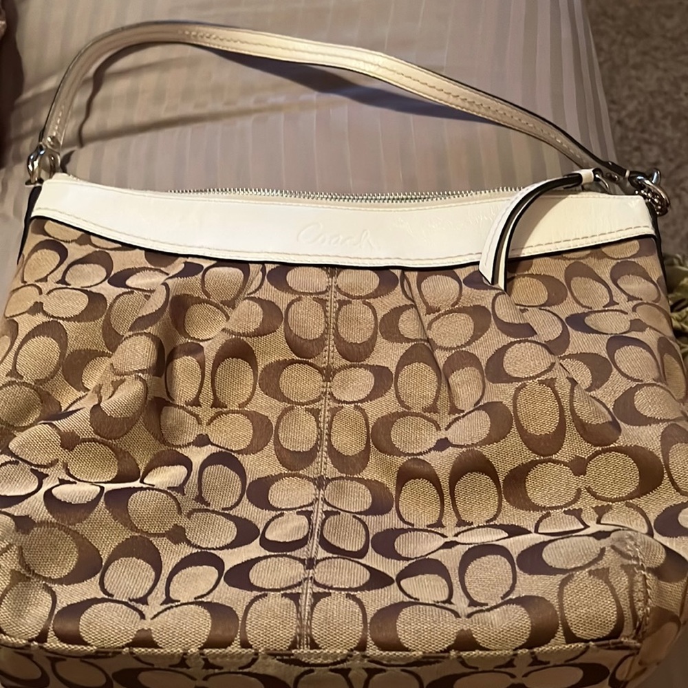 White leather with silver hardware and tan canvas coach